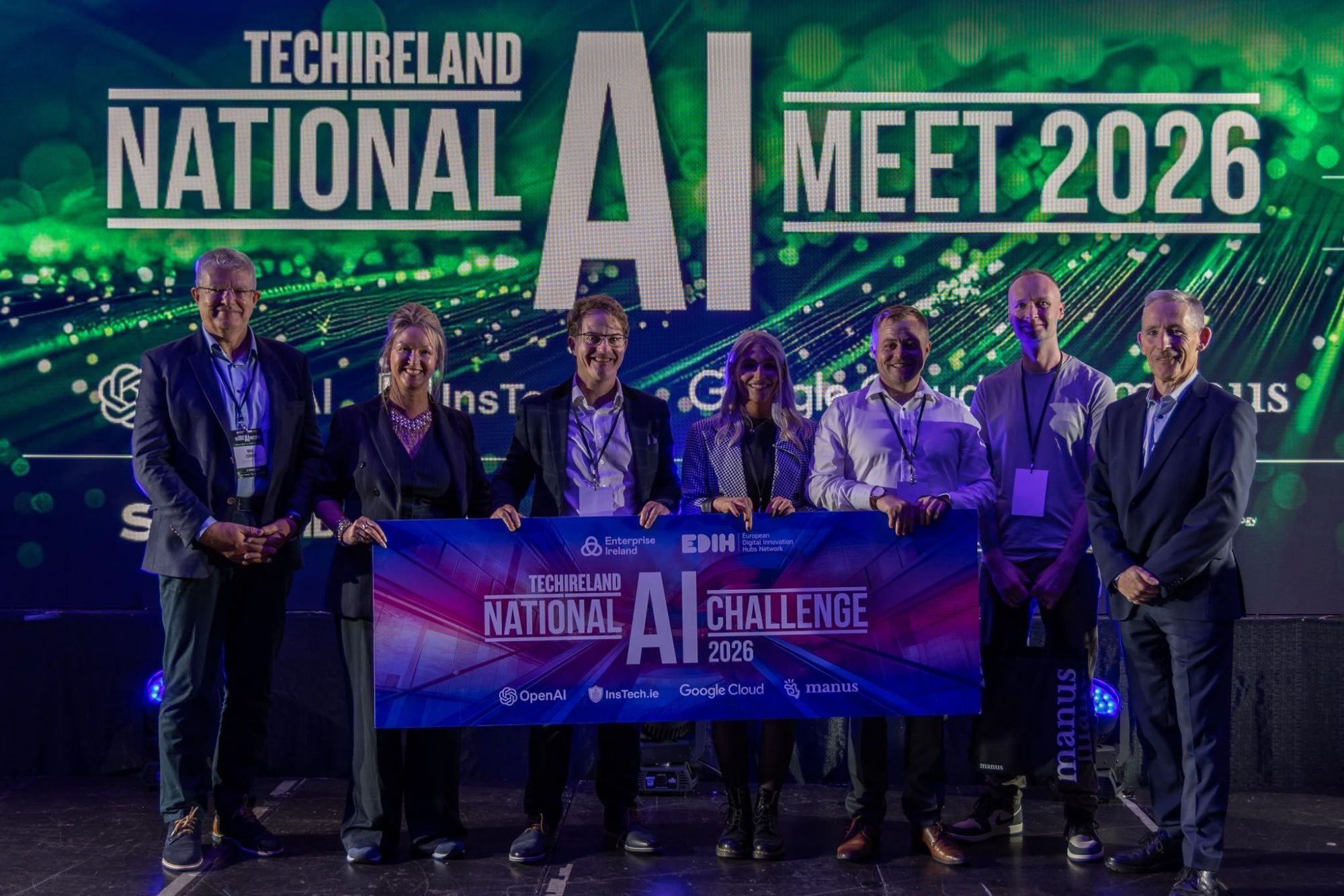 Max, Dayna and the team on stage at the TechIreland National AI Challenge 2026, holding the challenge banner